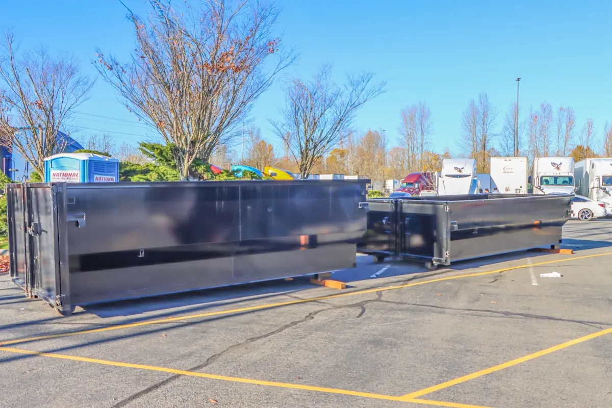 Professional dumpster rental service with roll-off container on residential driveway in Blythe